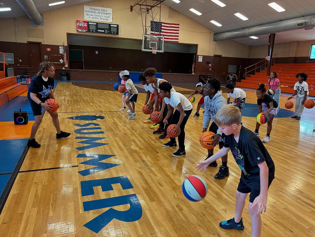 Youth learning basketball drills at ELW summer camp